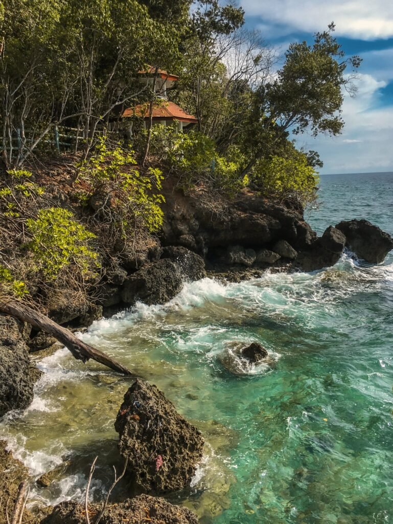 a rocky beach with a pagoda